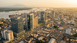 Aerial panoramic view of Douala city skyline at golden hour, representing the investment opportunities in Cameroon in 2026, with the port district visible in the background.