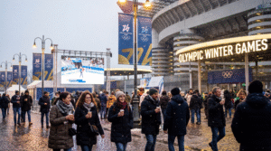 A winter evening outside San Siro Stadium during the 2026 Olympic Games, with diverse fans gathering under warm city lights.